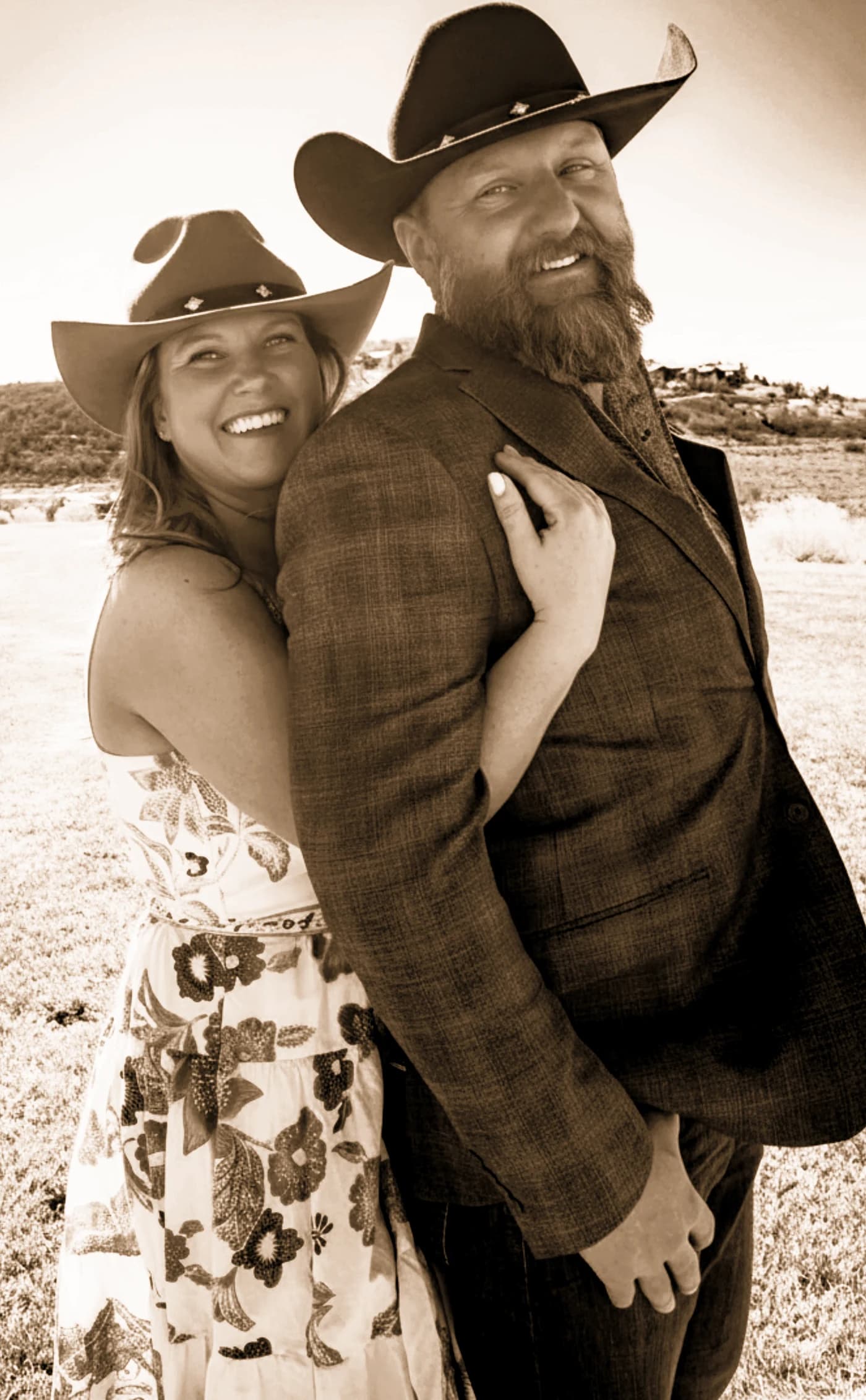 Mark and Kathy Bates, the owners of MK Mountain Canvas, standing together outdoors in cowboy hats